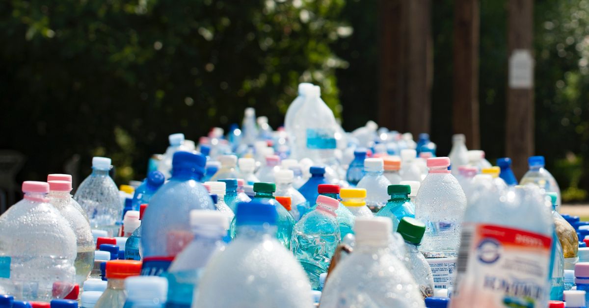 plastic bottle pollution piled up to show why plastic waste reduction is needed